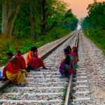 Southeast Asian women sitting on railroad tracks