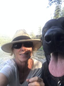 Megan (and her dog McDougal) by Swan Lake, Montana, where she grew up.